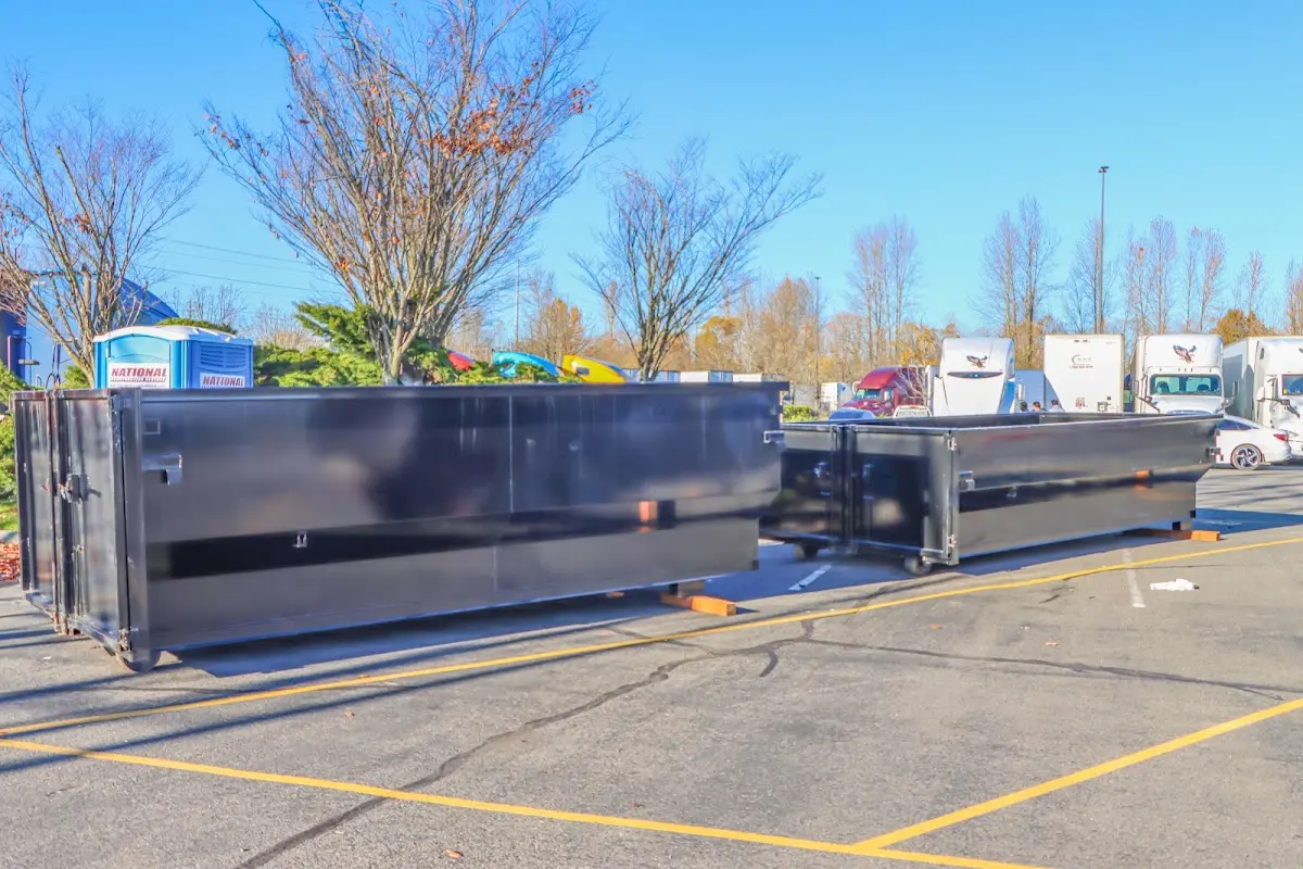 Professional dumpster rental service with roll-off container on residential driveway in Mechanicsville
